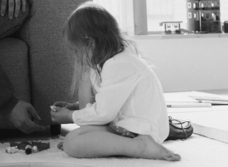 Black and White Header – Child Playing on the Floor